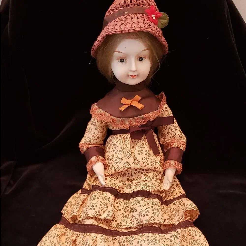Vintage Porcelain Doll with Brown Dress and Hat